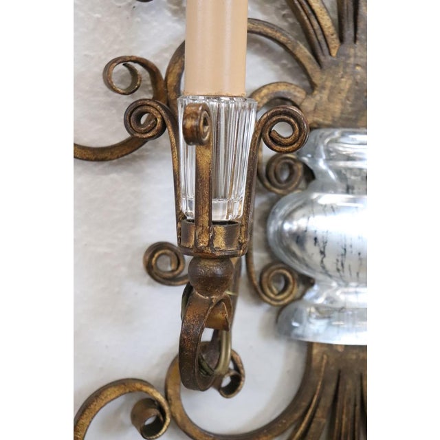 Rare pair of sconces by Maison Baguès, France circa 1950s. Made of gilded iron with delightful crystal details. The design...