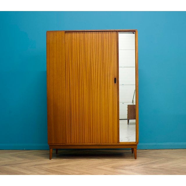 Mid-century wardrobe by Austinsuite, dating to the late 1950s–1960s. Featuring a sliding tambour door and a full-length...