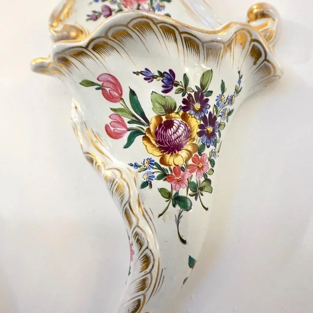 A delightful cornucopia-shaped Faience wall decoration signed Angoulême, a flower holder wall pocket in ivory white tin-...