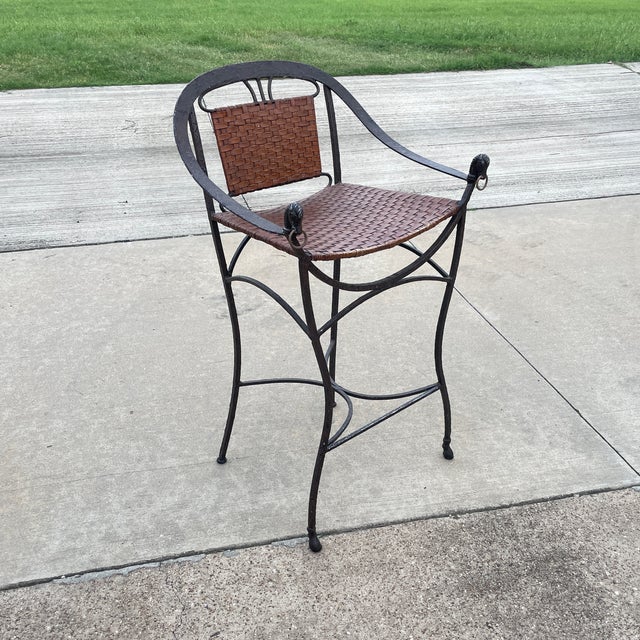 Iron Horseshoe Back and Leather Chairs in an antique brown finish. Seats and arm rests arm are in woven webbed design. Arm...