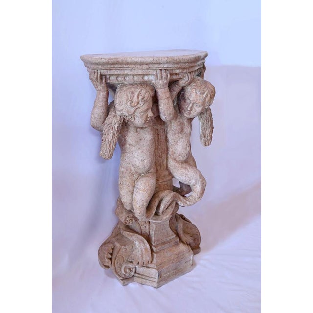 This marble saddle depicts two tritons supporting a tray. These two protagonists, wearing a garland on their shoulders,...