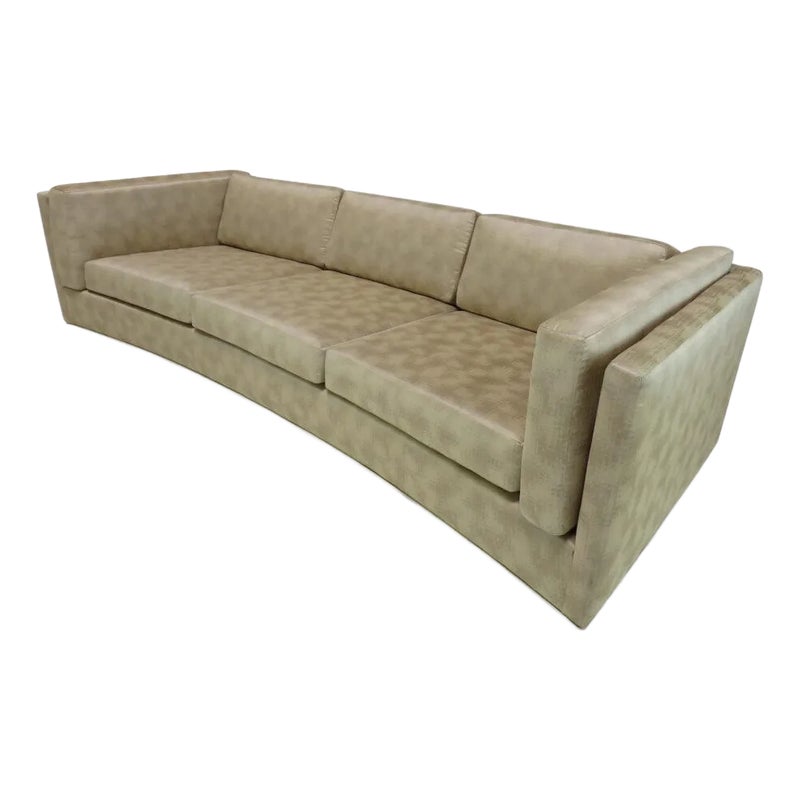A beige sectional sofa with three seats and a low back