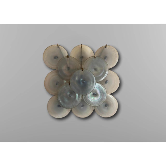 Wall lamp with iridescent blue Murano glass discs Italy 1960. The wall lamp rests on a nickel-plated metal structure with...