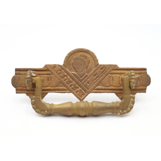 Antique Eastlake figural style drawer pulls made of brass with a patina finish. The finishes are different. Good condition...