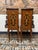 A stunning pair of bedside lockers with elegant marquetry inlay throughout. Featuring beautiful wood veneer, brass...