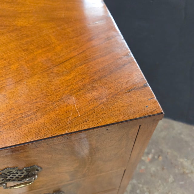 This English Burl Walnut 4 Drawer Chest With Brass Handles on Bracket Feet has a beautiful finish. It is a nice cleas...