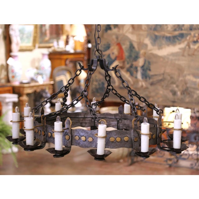 Illuminate a dining room or entryway with this impressive round chandelier. Crafted in France circa 1920, the hand-forged...