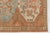 This is a vintage Turkish Oushak rug from the Mid 20th Century. The piece was hand-knotted.