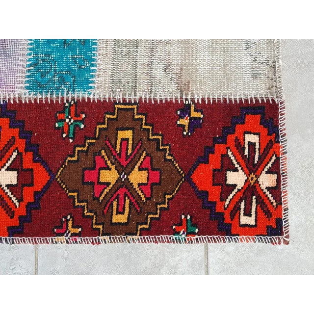 This is a vintage Turkish Oushak rug from the Mid 20th Century. The piece was hand-knotted.