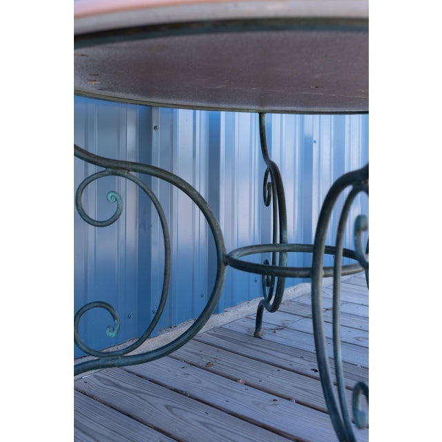 A charming example of classic French garden design, this vintage iron table features an elegant hand-forged green base...