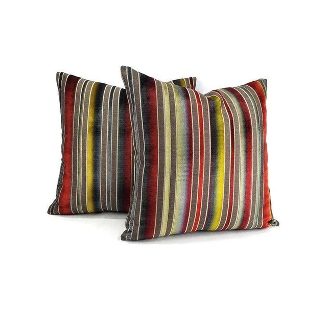 From S. Harris is Siri Stripe in the color Sanguine pillow cover. It features colors of a sunset in the cut velvet lines....