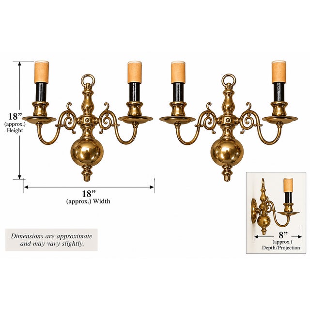 A handsome pair of vintage two-arm wall sconces featuring classic brass-toned construction, rounded ball-form bodies,...