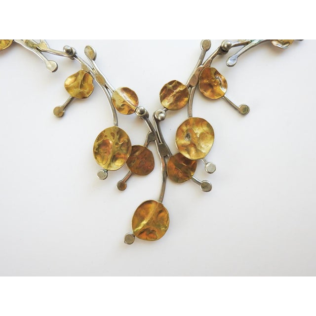 Late 20th century brass and white metal artist handmade free form necklace. Brass foliate accents on white metal (possibly...
