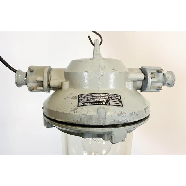 Grey industrial light with massive protective glass bulb. Made in former Czechoslovakia by Elektrosvit during the 1970s....