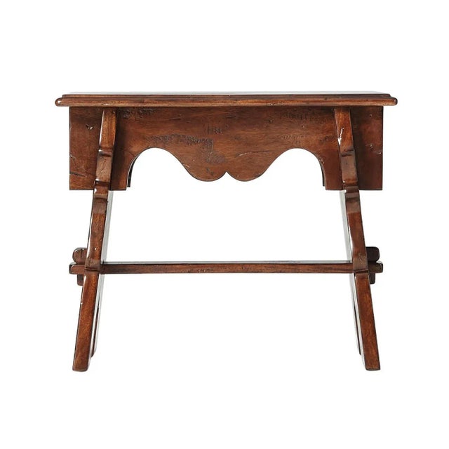 An antiqued wood ‘Joynt’ stool, with a serpentine apron on pegged splay legs joined by a stretcher. The original 17th...
