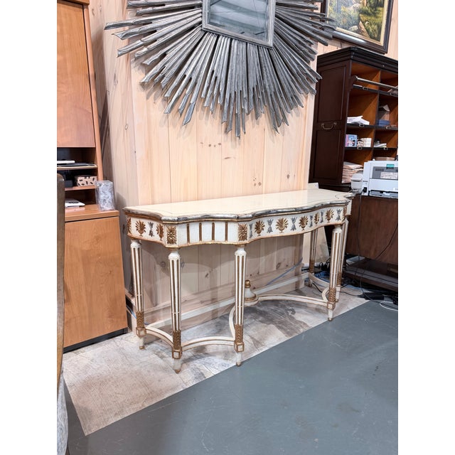 An elegant Louis XVI style demi lune console table showcasing refined neoclassical design and exceptional decorative...
