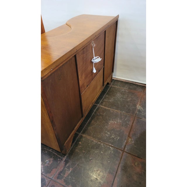 A Fantastic Light Golden Oak Cocktail Cabinet Bar. This one made by Beautility Co. Europe and comes with an updated light....