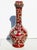 English Art glass vase. A garlic-headed vase with a Chinoiserie enameled pattern over the whole surface. Opaque red/brown...