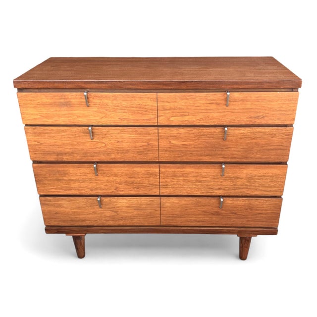 This beautifully restored Mid-Century Modern walnut chest of drawers is a timeless example of clean architectural design...