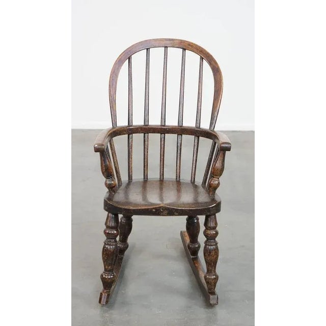 Very nice antique English Windsor children's rocking chair from the early 19th century. This extremely charming antique...