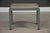 An art deco 1930’s metal bench designed by Norman Bel Geddes for Simmons Furniture in a new beige tweed fabric and...