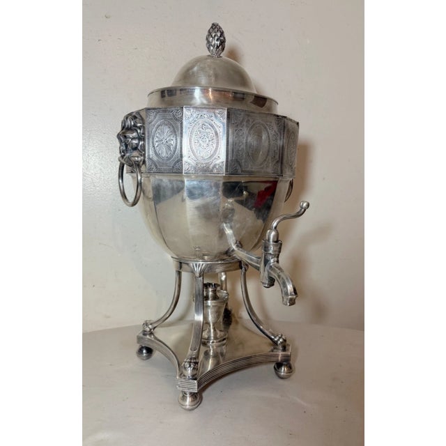 This Antique English Sheffield Plate Hot Water Urn with Lion Handles is a rare and elegant piece from the early 19th...