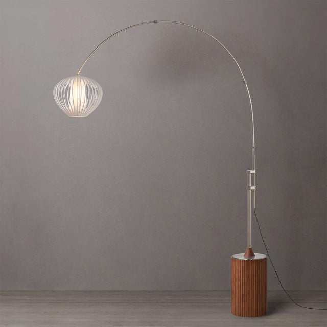 The Tambo Arc Floor Lamp is a dimmable lighting solution with a satin nickel body and a sphere white satin steel shade,...