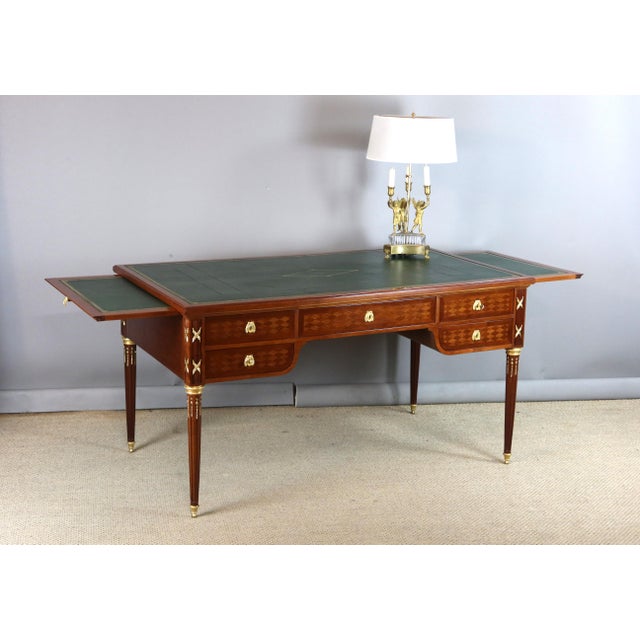 A 19th-century Louis XVI-style double-sided walnut desk. This desk features drawers (ten in total) on both sides, as well...