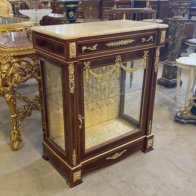 In love with the yellow upholstery. Stunning french vitrine. Has a beautiful gold details in the glass doors. Inside the...