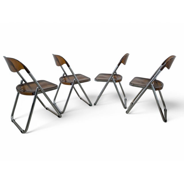 Set of 4 vintage folding chairs from the 70s. The body is chromed with lucite back and seat. The chair is perfect for...