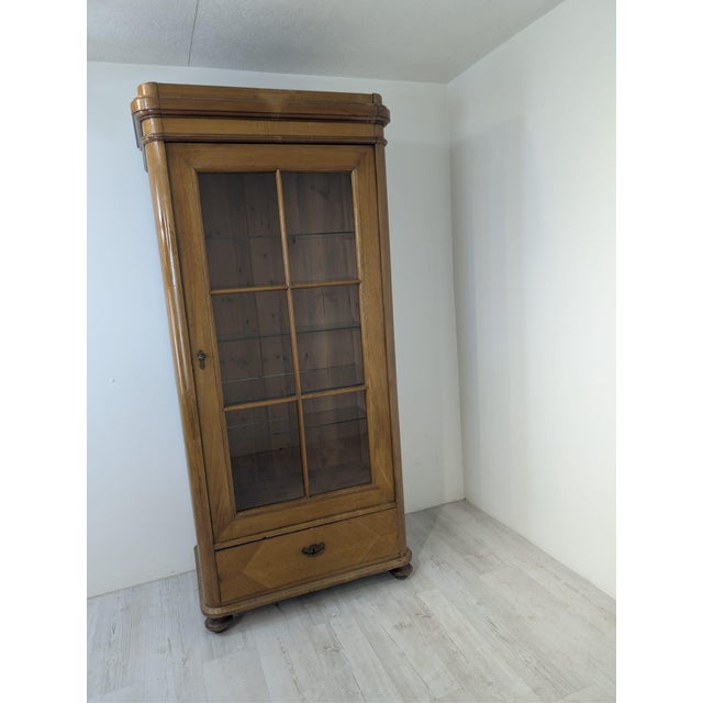 Antique Solid Wood Display Cabinet in Walnut The piece shown is a wooden display cabinet (or reference bookcase) made of...