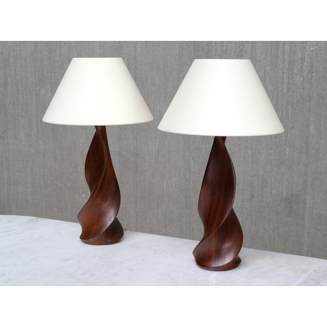 This rare pair of sculptural table lamps was designed and produced by the french wood artist claude chauvy in his workshop...