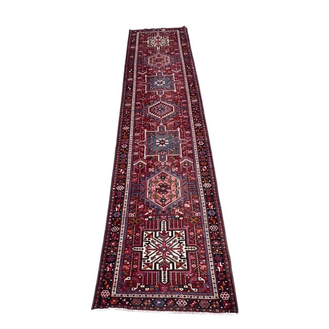 Vintage Persian Karajeh runner rug, hand-knotted in Iran from 100% wool. Measuring 2’8” x 11’2”, the rug features a...
