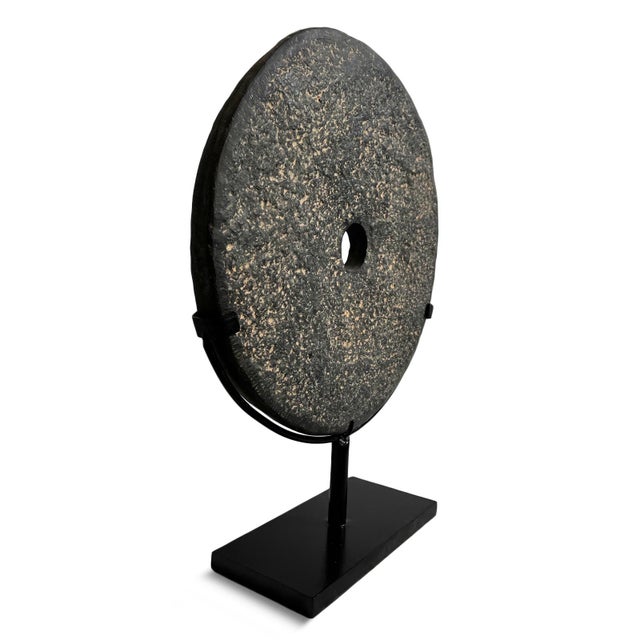 Beautiful modern minimalist style vintage black stone disk on iron stand. Textured chiseled stone each unique in natural...