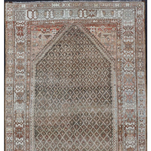 Softly colored antique distressed Persian Kurdish with all-over tribal design in soft colors of gray, charcoal, brown, tan...