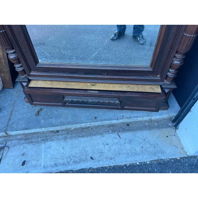 The Rosewood Antique French Louis XV Rococo Mirrored Armoire is a luxurious and elegant piece of furniture originating...