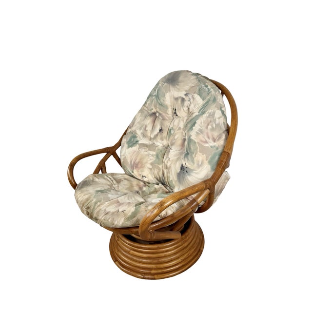 A wonderfully relaxed vintage rattan lounge chair featuring a sculptural bent-rattan frame, open looping arms, tufted...
