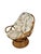 A wonderfully relaxed vintage rattan lounge chair featuring a sculptural bent-rattan frame, open looping arms, tufted...