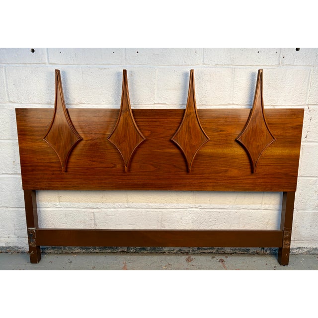 A striking mid-century modern queen-size headboard crafted from richly grained walnut in a sculptural, architectural form....