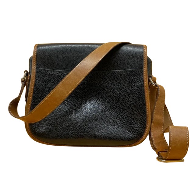 Classic vintage Celine crossbody bag crafted in pebbled black leather with contrasting cognac brown leather trim and...