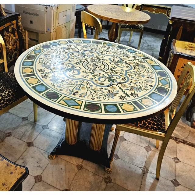 Make a striking statement in your dining space with this grand round French-style dining table, featuring an exceptionally...