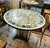 Make a striking statement in your dining space with this grand round French-style dining table, featuring an exceptionally...