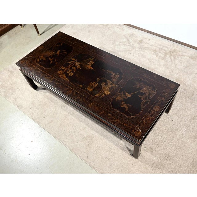 Long rectangular coffee table in black lacquer decorated with traditional Chinese scenes representing characters with...