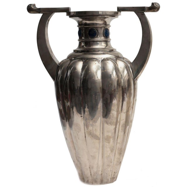 Pair of important two-handles vases in silver 800, body with wide flutings, neck with sodalite stones. Signed on base...