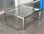 A striking example of modernist design, this square coffee table pairs a thick, inset tempered glass top with a polished...