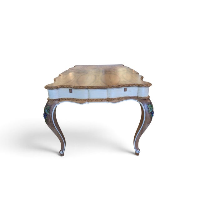 This fully restored table in fine walnut features a contoured top with a refined open-spot veneer and a contrasting light...