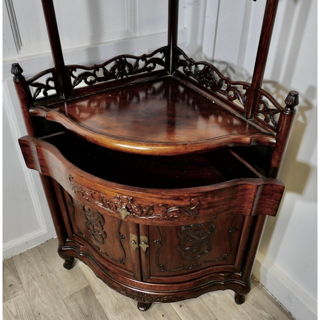 Oriental Style Carved Corner Etagere with Cupboard and Drawer A superb piece with 3 pierced gallery shelves over a bow...