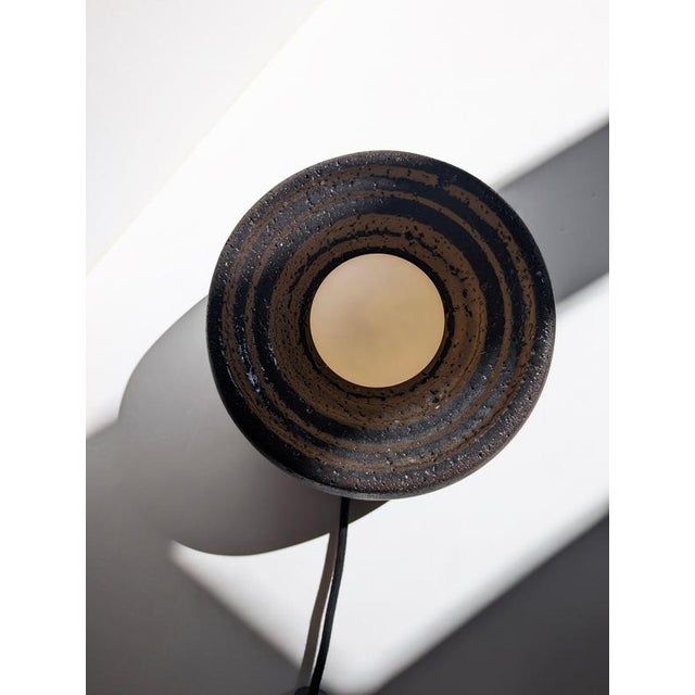 Caldera partially glazed lava stone table lamp by clemence birot dimensions: ø 25 x h 15 cm materials: stone caldera is a...