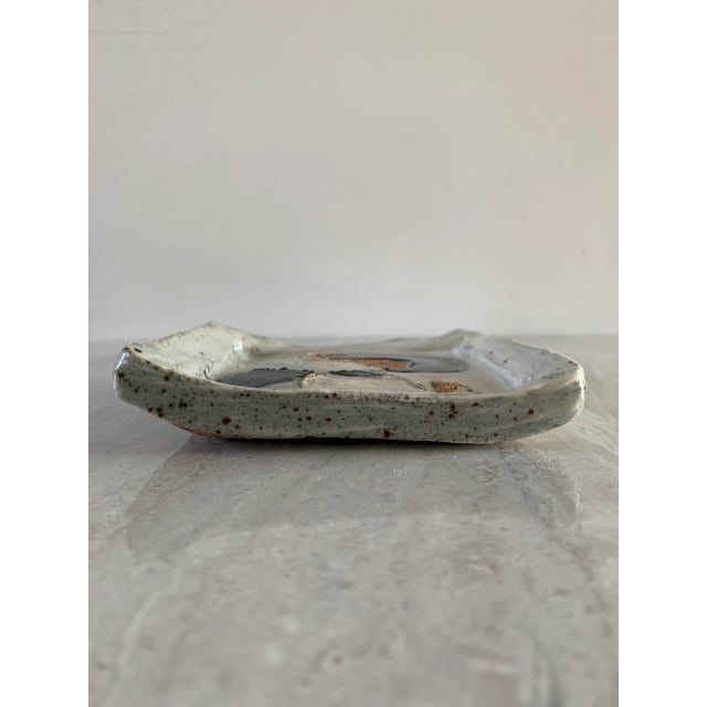 Stoneware ceramic tray dish with a monochromatic abstract flowing decoration with a mix of glazed and unglazed areas.