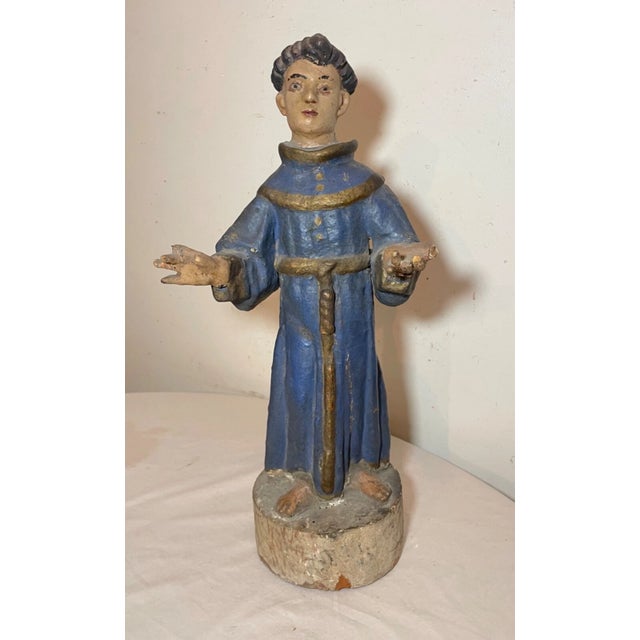 Immerse yourself in the spiritual artistry of the 17th century with this sizable antique St. Francis Santos sculpture....